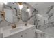 Modern bathroom featuring marble walls, double vanity, gold fixtures, and a glass-enclosed shower at 1095 Lyndhurst Way, Roswell, GA 30075