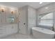 Bright bathroom with a free standing tub and a modern vanity at 1095 Lyndhurst Way, Roswell, GA 30075