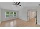 Spacious bedroom featuring a ceiling fan and large window at 1095 Lyndhurst Way, Roswell, GA 30075