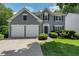 Charming home featuring a manicured lawn, two-car garage, and inviting curb appeal at 1095 Lyndhurst Way, Roswell, GA 30075