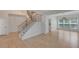 Inviting foyer features hardwood floors, staircase and dining area with modern lighting at 1095 Lyndhurst Way, Roswell, GA 30075