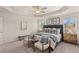 Spacious main bedroom showcases a tray ceiling, natural light, plush carpet, and a stylish accent chair at 1328 Magnolia Bend Way # 289, Jonesboro, GA 30238