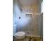 Updated bathroom featuring marble tile shower with mosaic floor and recessed shelf at 1930 Rocky Mill Ln, Lawrenceville, GA 30044