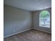 Bedroom featuring neutral carpeting, fresh paint and an arch-top window at 1930 Rocky Mill Ln, Lawrenceville, GA 30044
