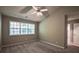 Bright bedroom featuring a ceiling fan and a large window allowing natural light at 1930 Rocky Mill Ln, Lawrenceville, GA 30044