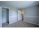 Cozy bedroom with neutral carpeting, fresh paint and an open closet space at 1930 Rocky Mill Ln, Lawrenceville, GA 30044