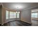 Bright dining room featuring a bay window, chandelier, updated flooring, and neutral walls at 1930 Rocky Mill Ln, Lawrenceville, GA 30044