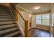 Entryway features updated flooring, staircase, and easy access to a half bathroom at 1930 Rocky Mill Ln, Lawrenceville, GA 30044