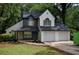 Charming two-story home featuring a two-car garage, attractive landscaping and a inviting front entry at 1930 Rocky Mill Ln, Lawrenceville, GA 30044