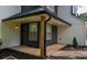 Covered front porch with black trim, offers a warm welcome into the home at 1930 Rocky Mill Ln, Lawrenceville, GA 30044