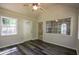 Bright sunroom featuring wood look floors, ceiling fan and multiple windows at 1930 Rocky Mill Ln, Lawrenceville, GA 30044