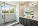 Bright bathroom features a glass enclosed shower with white marble wall and a gray vanity with double sinks at 2144 Tidwell Ln # 2, Atlanta, GA 30318