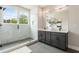 Modern bathroom with a glass-enclosed shower, dual vanities, and elegant fixtures for a spa-like experience at 2144 Tidwell Ln # 2, Atlanta, GA 30318