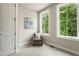 Cozy bedroom with neutral carpet, and a comfortable armchair next to large windows overlooking lush greenery at 2144 Tidwell Ln # 2, Atlanta, GA 30318