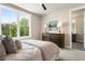 Bright bedroom featuring a large window, dresser, and comfortable bedding in a neutral palette at 2144 Tidwell Ln # 2, Atlanta, GA 30318