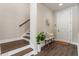 Welcoming entryway with wooden staircase, bench seating, and a stylish welcome mat at 2144 Tidwell Ln # 2, Atlanta, GA 30318