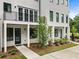 Beautiful townhome with a covered entry, black framed windows, and a professionally landscaped yard at 2144 Tidwell Ln # 2, Atlanta, GA 30318