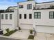 Contemporary townhome with a white facade, black framed windows, and attached garages at 2144 Tidwell Ln # 2, Atlanta, GA 30318