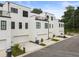 Modern townhome exterior with white brick, black framed windows, and a rooftop terrace at 2144 Tidwell Ln # 2, Atlanta, GA 30318
