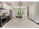 Spacious kitchen island features a sink, a view to the backyard, and modern pendant lights at 2144 Tidwell Ln # 2, Atlanta, GA 30318