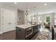 Modern kitchen island with stainless steel appliances and pendant lighting open to living area at 2144 Tidwell Ln # 2, Atlanta, GA 30318