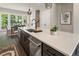 Kitchen island with stainless appliances, sink, and modern black faucet overlooking dining area at 2144 Tidwell Ln # 2, Atlanta, GA 30318