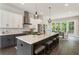A modern kitchen boasts an island with barstool seating and a view to the backyard at 2144 Tidwell Ln # 2, Atlanta, GA 30318