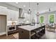 Modern kitchen with oversized island, stainless steel appliances, white cabinets, and an open floor plan to the living room at 2144 Tidwell Ln # 2, Atlanta, GA 30318