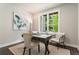 Serene office featuring a sleek desk and chairs with views of lush greenery outside the window at 2144 Tidwell Ln # 2, Atlanta, GA 30318