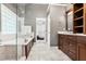 Bright bathroom featuring a glass-enclosed shower, soaking tub, and dual vanities at 7249 Village Creek Trce, Atlanta, GA 30328