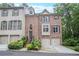 Exterior front view of brick home with two-car garage and landscaped front yard at 7249 Village Creek Trce, Atlanta, GA 30328