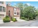 Charming brick townhome with a two-car garage, well-manicured landscaping, and inviting front entrance at 7249 Village Creek Trce, Atlanta, GA 30328