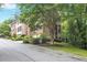 Exterior day shot of brick homes, featuring mature trees and landscaping at 7249 Village Creek Trce, Atlanta, GA 30328