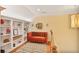 Hallway featuring a cozy seating area with built-in bookshelves and an accent rug at 7249 Village Creek Trce, Atlanta, GA 30328