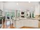 Bright kitchen with a marble countertop island, stainless steel appliances, and a fireplace in the adjoining living space at 7249 Village Creek Trce, Atlanta, GA 30328