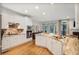 Kitchen with white cabinetry, marble countertops, hardwood flooring, and stainless steel appliances at 7249 Village Creek Trce, Atlanta, GA 30328