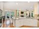 Open kitchen with a granite island overlooking a living room with a fireplace and outdoor deck at 7249 Village Creek Trce, Atlanta, GA 30328