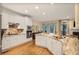 Bright kitchen features white cabinetry, stainless steel appliances, and granite countertops, with access to outdoor space at 7249 Village Creek Trce, Atlanta, GA 30328