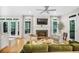 Bright living room with fireplace, hardwood floors, and French doors to the balcony at 7249 Village Creek Trce, Atlanta, GA 30328