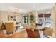 Sunlit living room with hardwood floors, elegant furniture, and large windows offering scenic views at 7249 Village Creek Trce, Atlanta, GA 30328