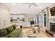 Open-concept living area with hardwood floors, a fireplace, and a modern kitchen, blending style and function at 7249 Village Creek Trce, Atlanta, GA 30328