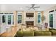 Comfortable living room with fireplace, French doors to porch, and backyard views, offering a cozy ambiance at 7249 Village Creek Trce, Atlanta, GA 30328