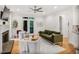 Bright living room with fireplace, hardwood floors, and French doors to the balcony at 7249 Village Creek Trce, Atlanta, GA 30328
