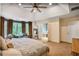 Spacious main bedroom with sitting area, view of the bathroom and a large bay window at 7249 Village Creek Trce, Atlanta, GA 30328