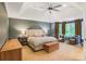 Serene main bedroom featuring tray ceilings, sitting area with bay windows, and soft, natural lighting at 7249 Village Creek Trce, Atlanta, GA 30328