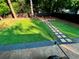 Lush backyard featuring a stone path, well-manicured lawn, and a cozy fire pit area for relaxing at 1038 Ralph Ne Rd, Atlanta, GA 30324