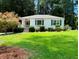 Charming single-story home with a well-maintained lawn and mature trees at 1038 Ralph Ne Rd, Atlanta, GA 30324
