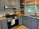 Updated kitchen with granite countertops, stainless steel appliances, and stylish blue cabinetry at 1038 Ralph Ne Rd, Atlanta, GA 30324