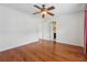A bedroom with hardwood floors and ceiling fan; a doorway shows a glimpse into an attached bathroom at 109 Windcroft Nw Cir, Acworth, GA 30101