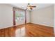 A bedroom with hardwood floors and a ceiling fan, with a window covered by blinds and curtains at 109 Windcroft Nw Cir, Acworth, GA 30101